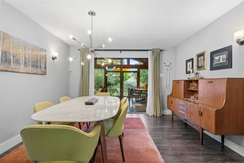 a view of a dining room with furniture window and wooden floor