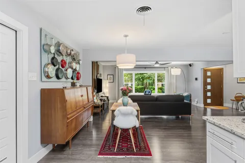 a living room with furniture a chandelier and a rug