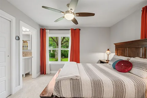 a bedroom with a bed dresser and a window