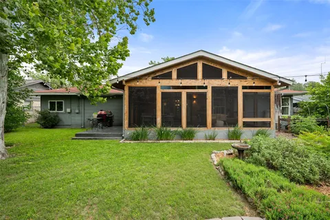 a view of a house with a yard and sitting area
