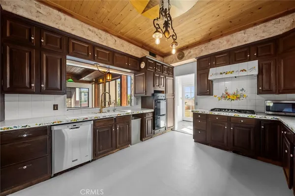 a bathroom with a granite countertop sink a mirror and a shower