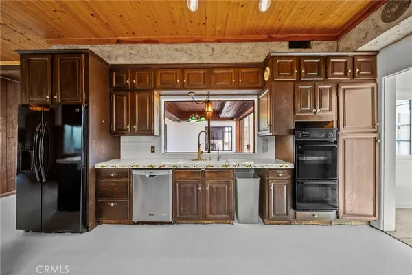 a view of washer and dryer with bathroom in the background