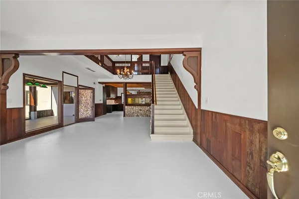 a view of staircase with lots of frames on wall and windows