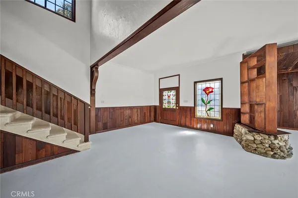 a view of an empty room with a fireplace and a window