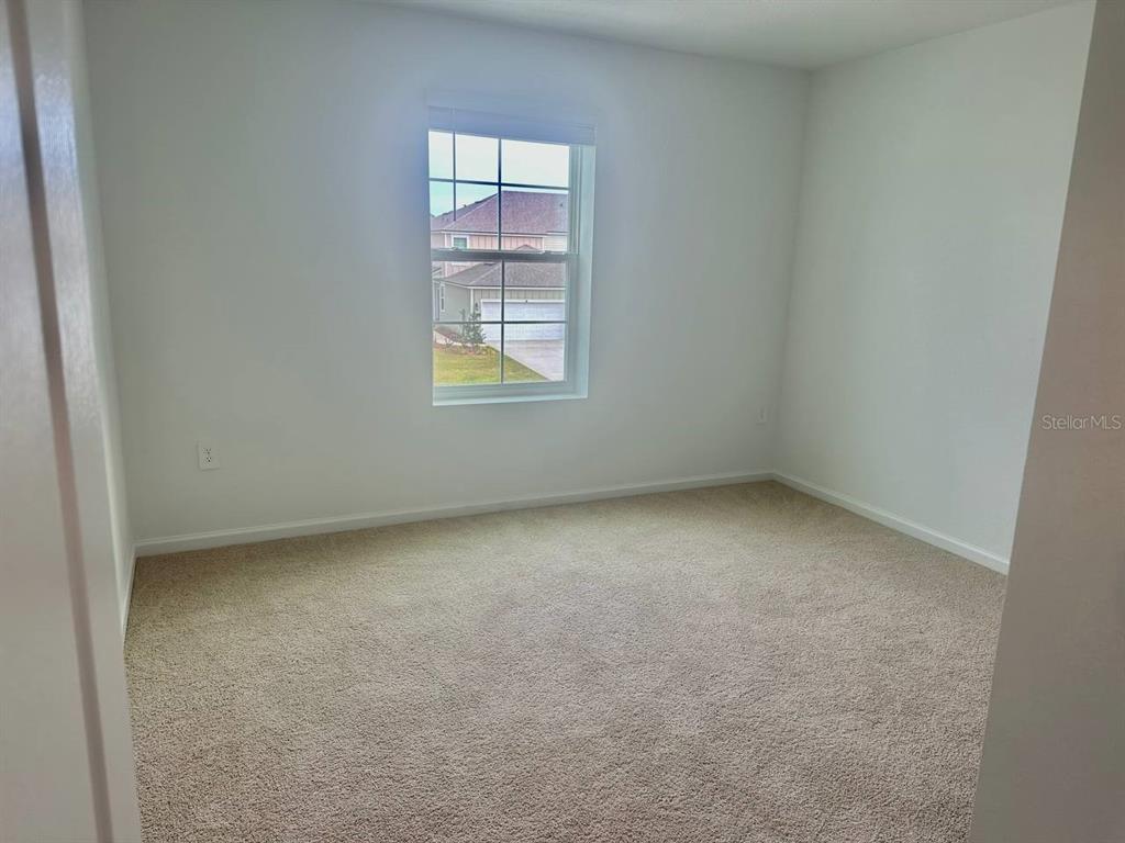 455 Redbud Road Palm Coast, FL 32137 - Photo 6 of 12 an empty room with windows