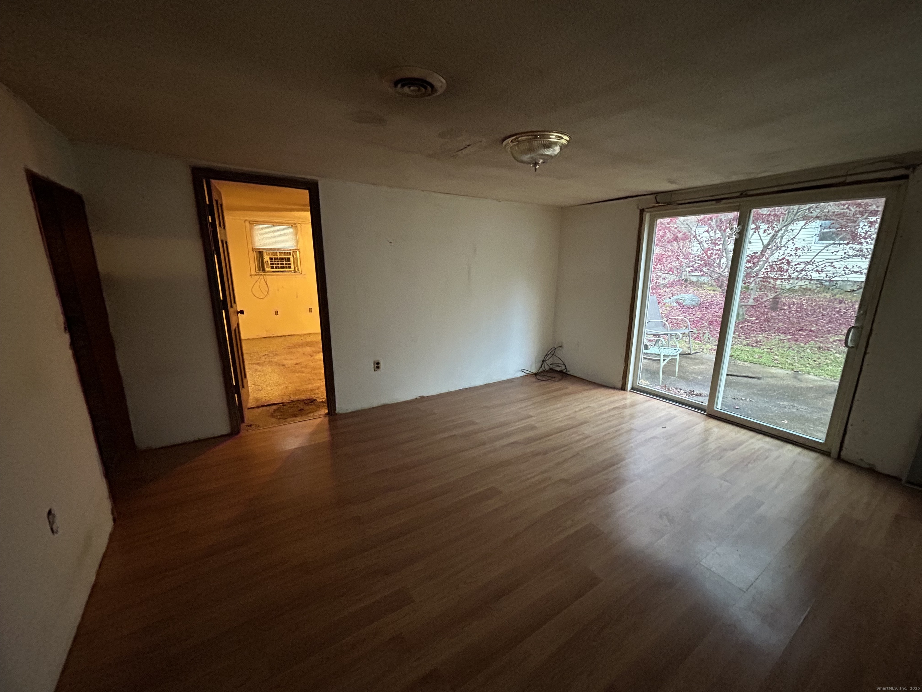 236 Union City Road Naugatuck, CT 06770 - Photo 13 of 28 an empty room with wooden floor and sliding door