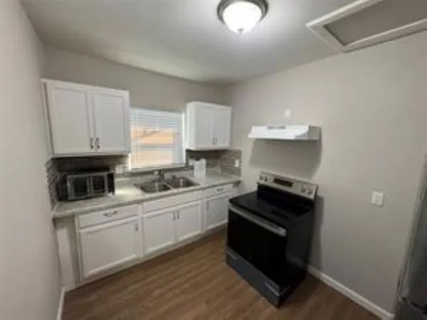 a kitchen with cabinets and appliances
