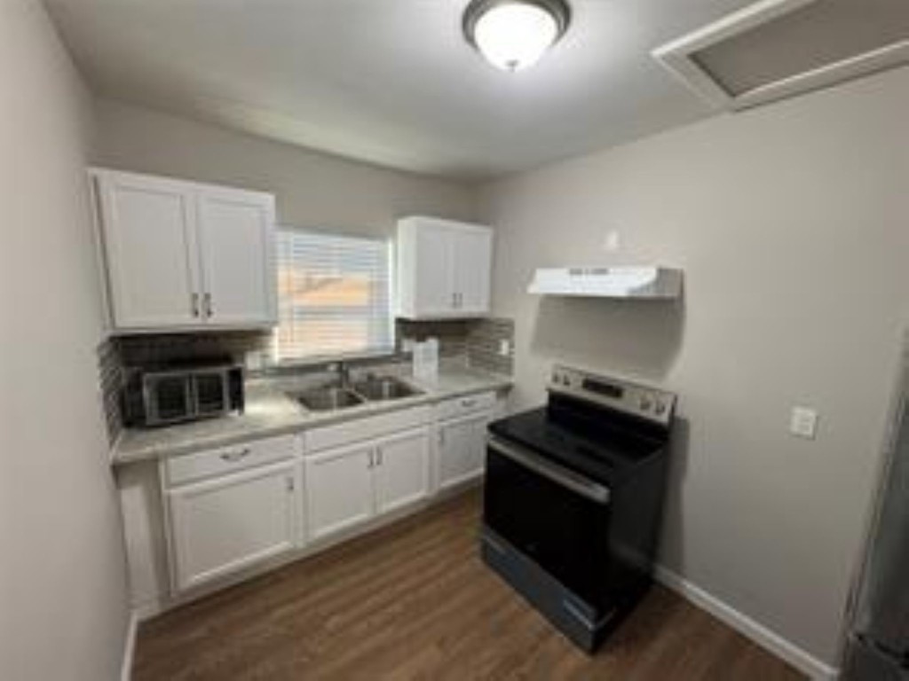 3231 Holman Street Houston, TX 77004 - Photo 2 of 6 a kitchen with cabinets and appliances