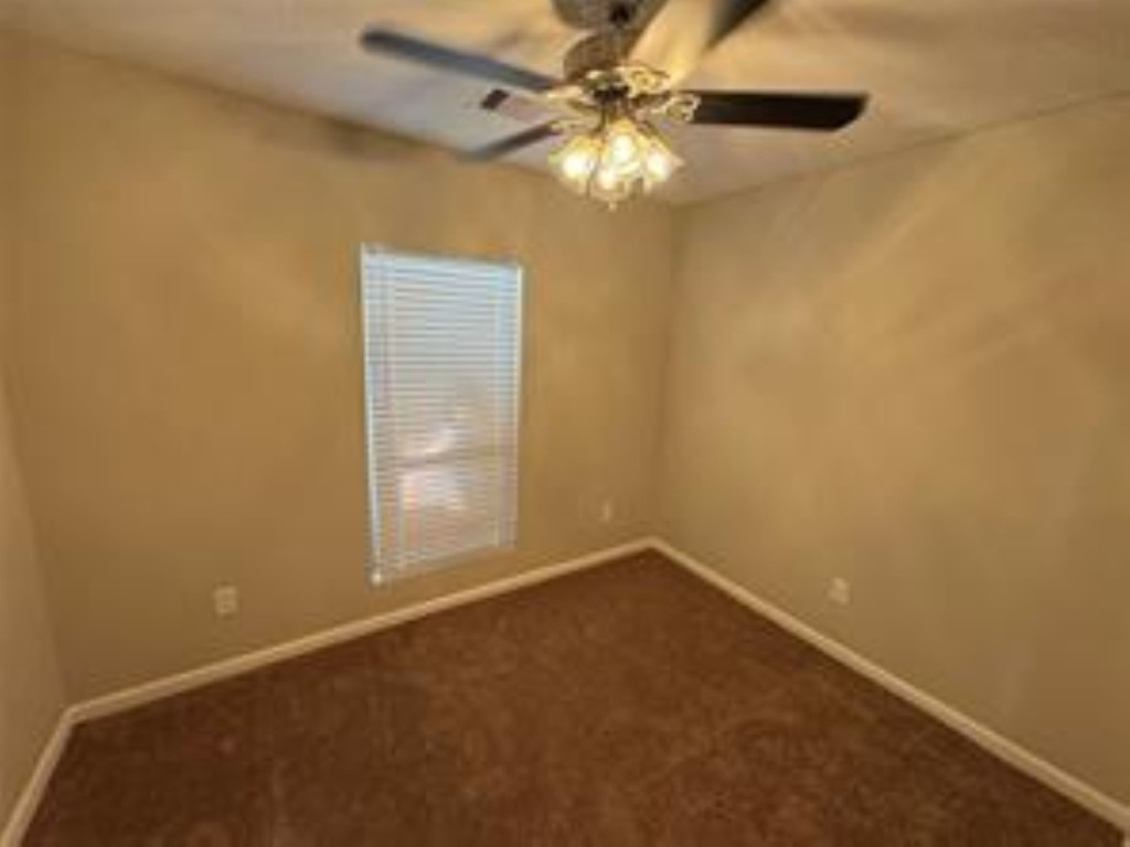 3231 Holman Street Houston, TX 77004 - Photo 4 of 6 an empty room with a window and a fan