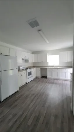 a view of a kitchen with wooden floor