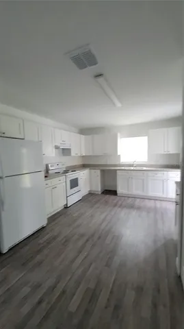 a view of a kitchen with wooden floor