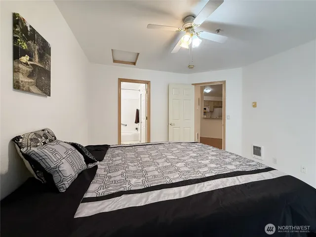 a bedroom with a bed and a chandelier