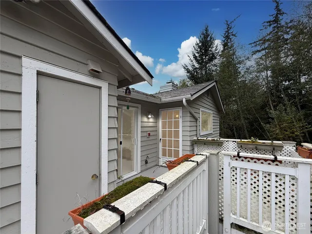 a view of house with deck and outdoor seating