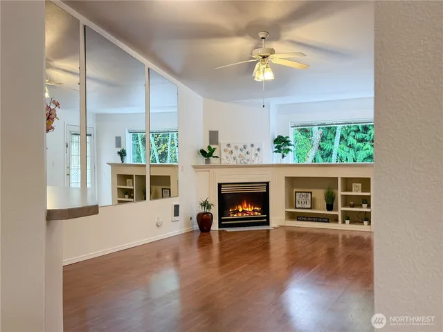 a living room with a fireplace and a flat screen tv