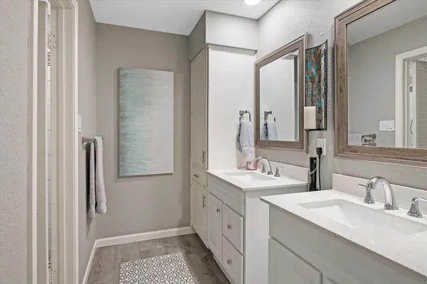 a bathroom with a double vanity sink and a mirror