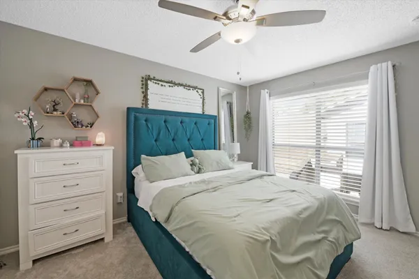 a bedroom with a bed and a window