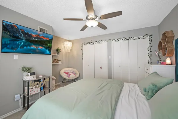 a bedroom with a bed and a chandelier