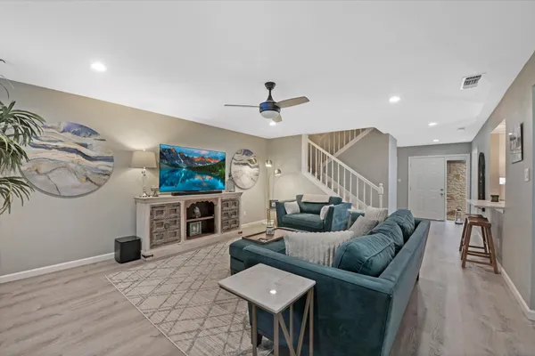 a living room with furniture and a flat screen tv