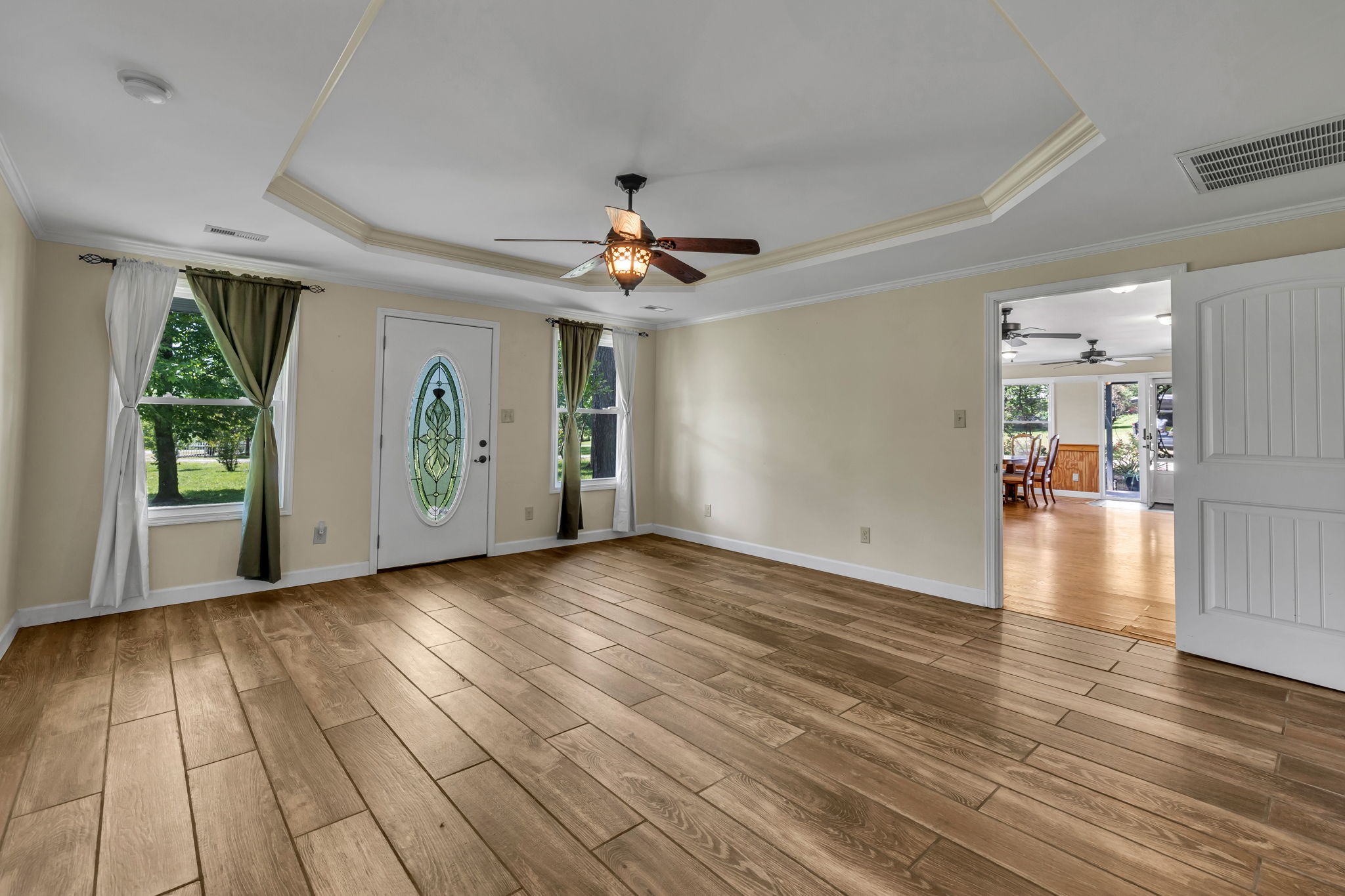427 Telegraph Street Tennessee Ridge, TN 37178 - Photo 16 of 47 a view of a livingroom with wooden floor a ceiling fan and windows