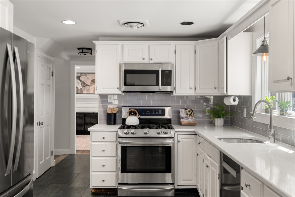40 Hooper Street Westwood, MA 02090 - Photo 13 of 39 a kitchen with stainless steel appliances a stove a sink and a microwave