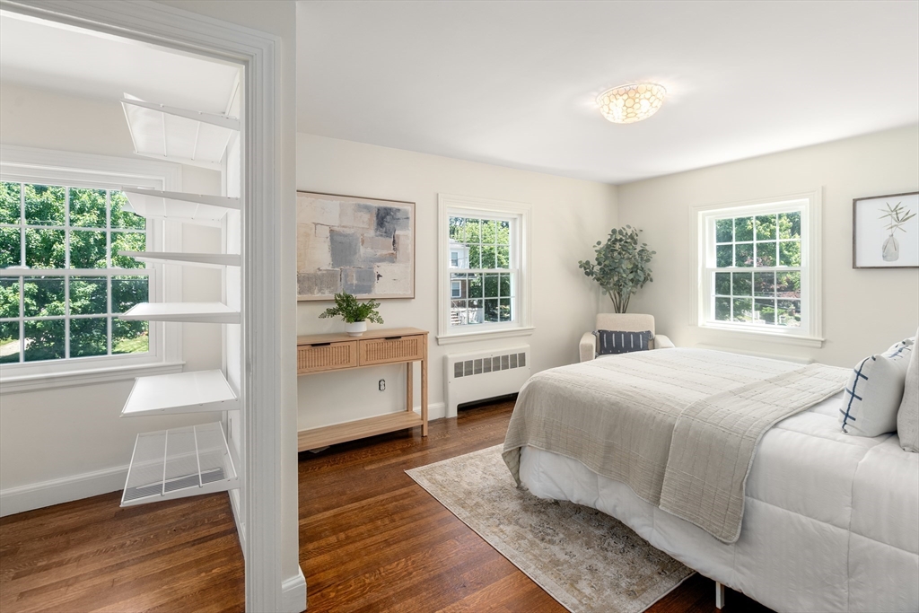 40 Hooper Street Westwood, MA 02090 - Photo 23 of 39 a bedroom with a large white bed and wooden floor