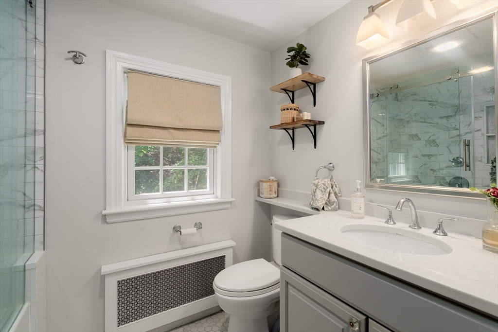 40 Hooper Street Westwood, MA 02090 - Photo 27 of 39 a bathroom with a granite countertop sink a toilet and a mirror
