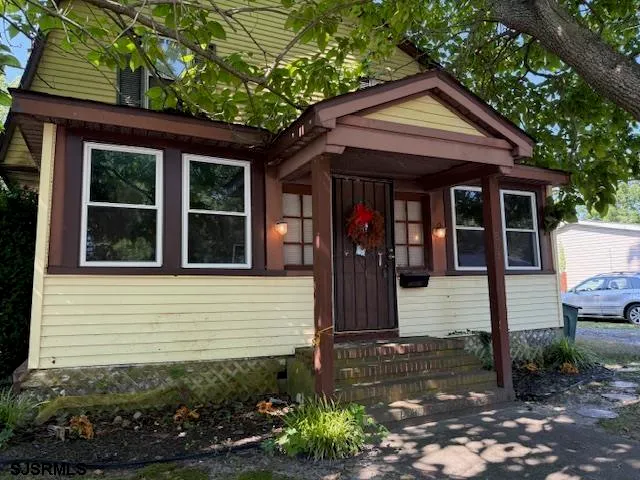 a view of a house with potted plants