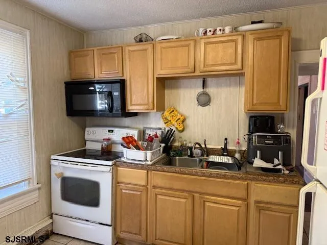 a white refrigerator freezer sitting in a kitchen