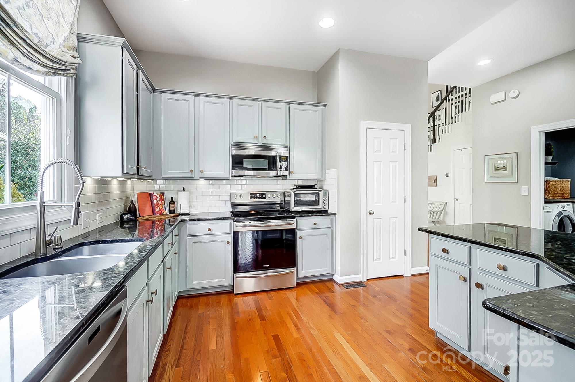134 Mills Lane Fort Mill, SC 29708 - Photo 11 of 45 a kitchen with stainless steel appliances granite countertop a sink stove and refrigerator