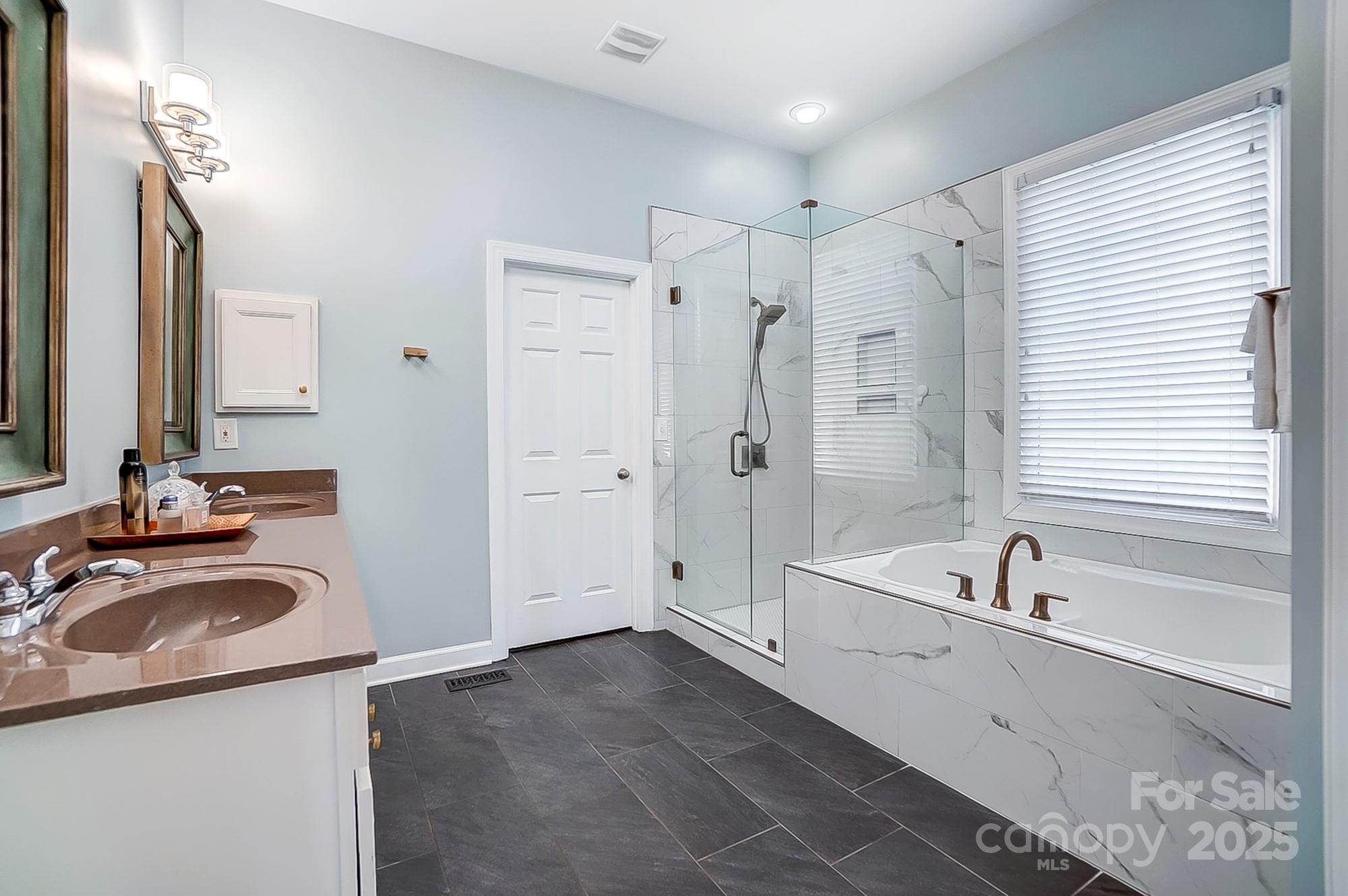 134 Mills Lane Fort Mill, SC 29708 - Photo 23 of 45 a bathroom with a tub sink and mirror