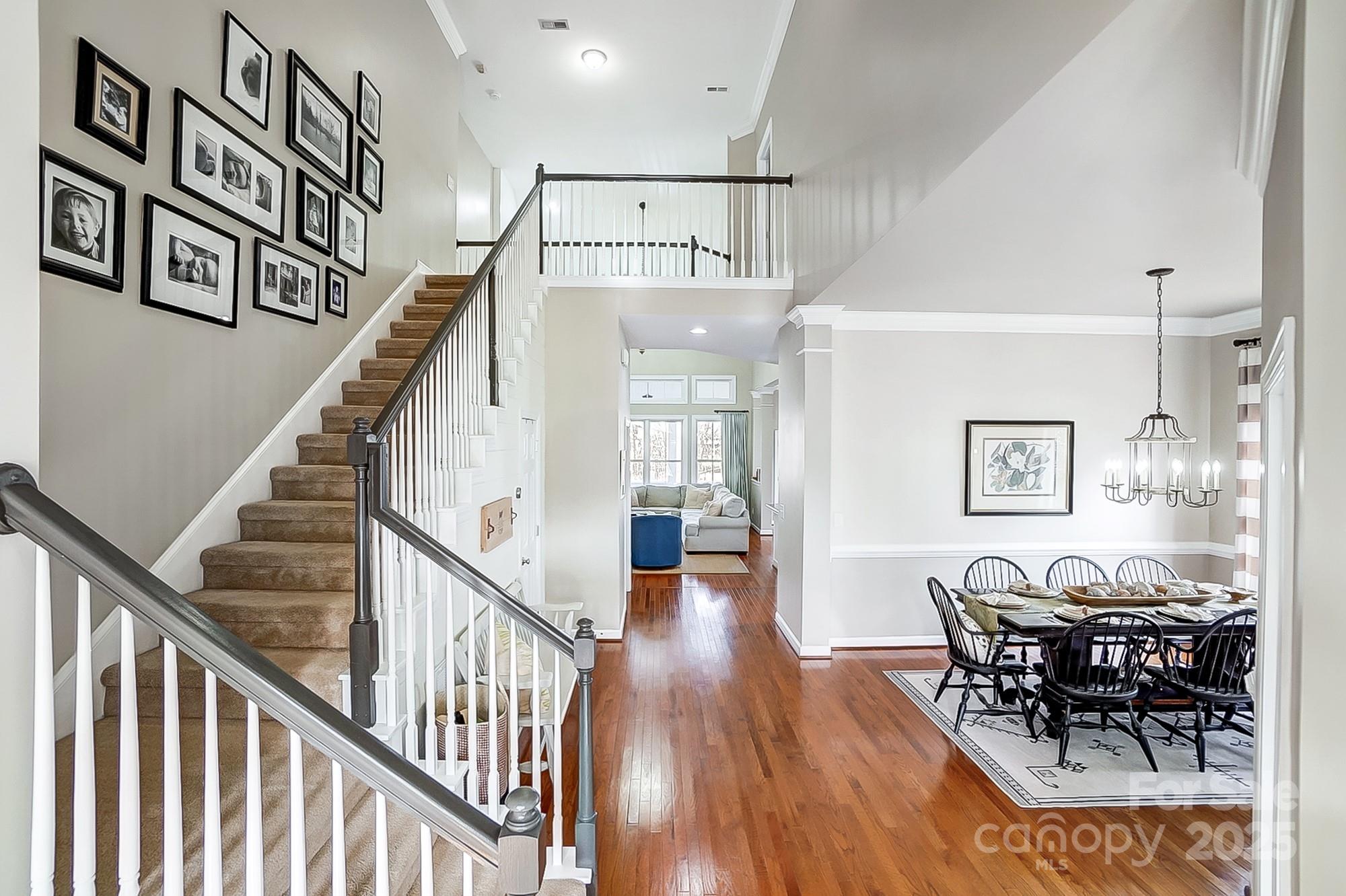 134 Mills Lane Fort Mill, SC 29708 - Photo 27 of 45 a view of dining room and livingroom with furniture wooden floor and windows