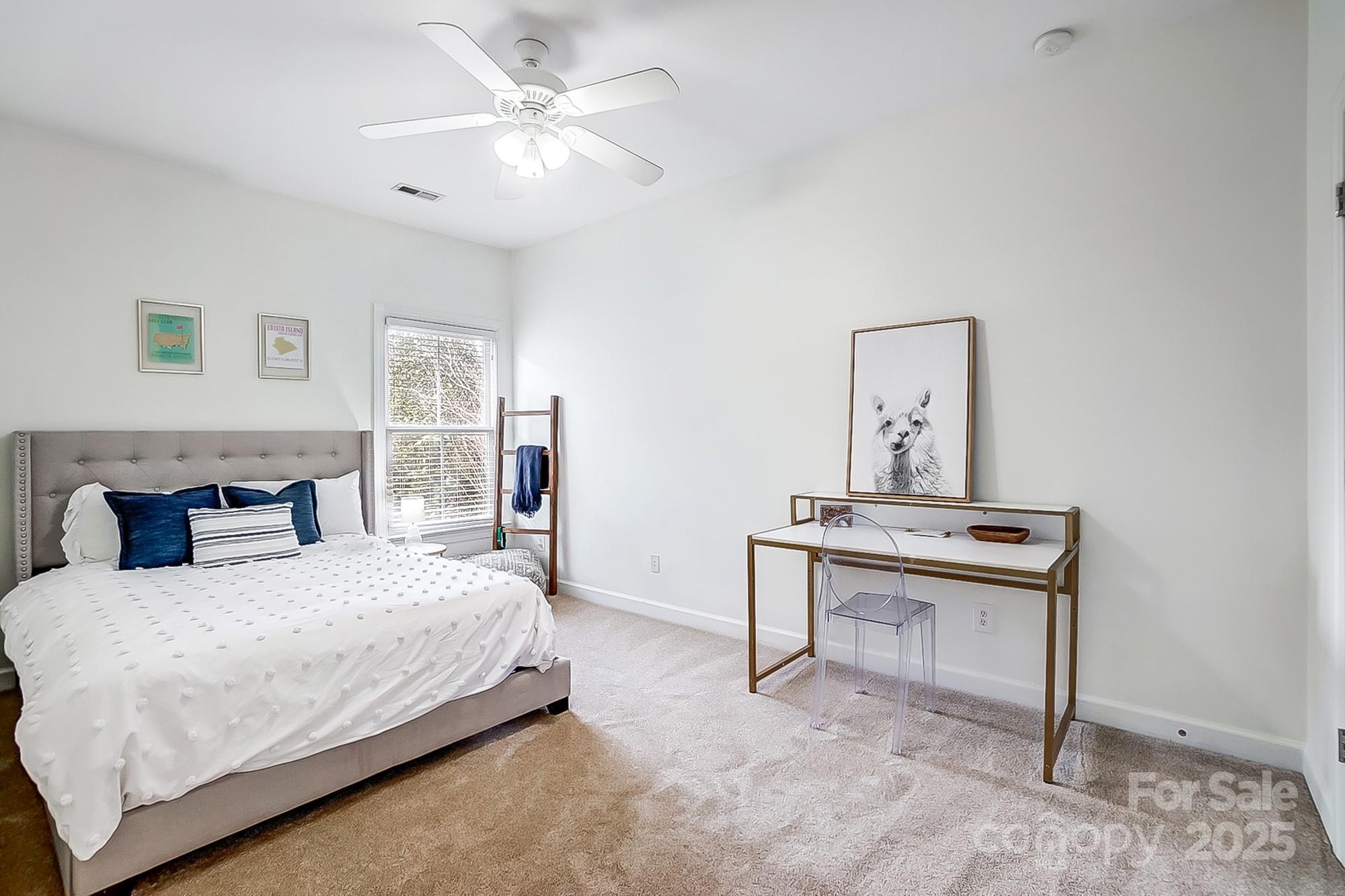 134 Mills Lane Fort Mill, SC 29708 - Photo 30 of 45 a bedroom with a bed and a chandelier