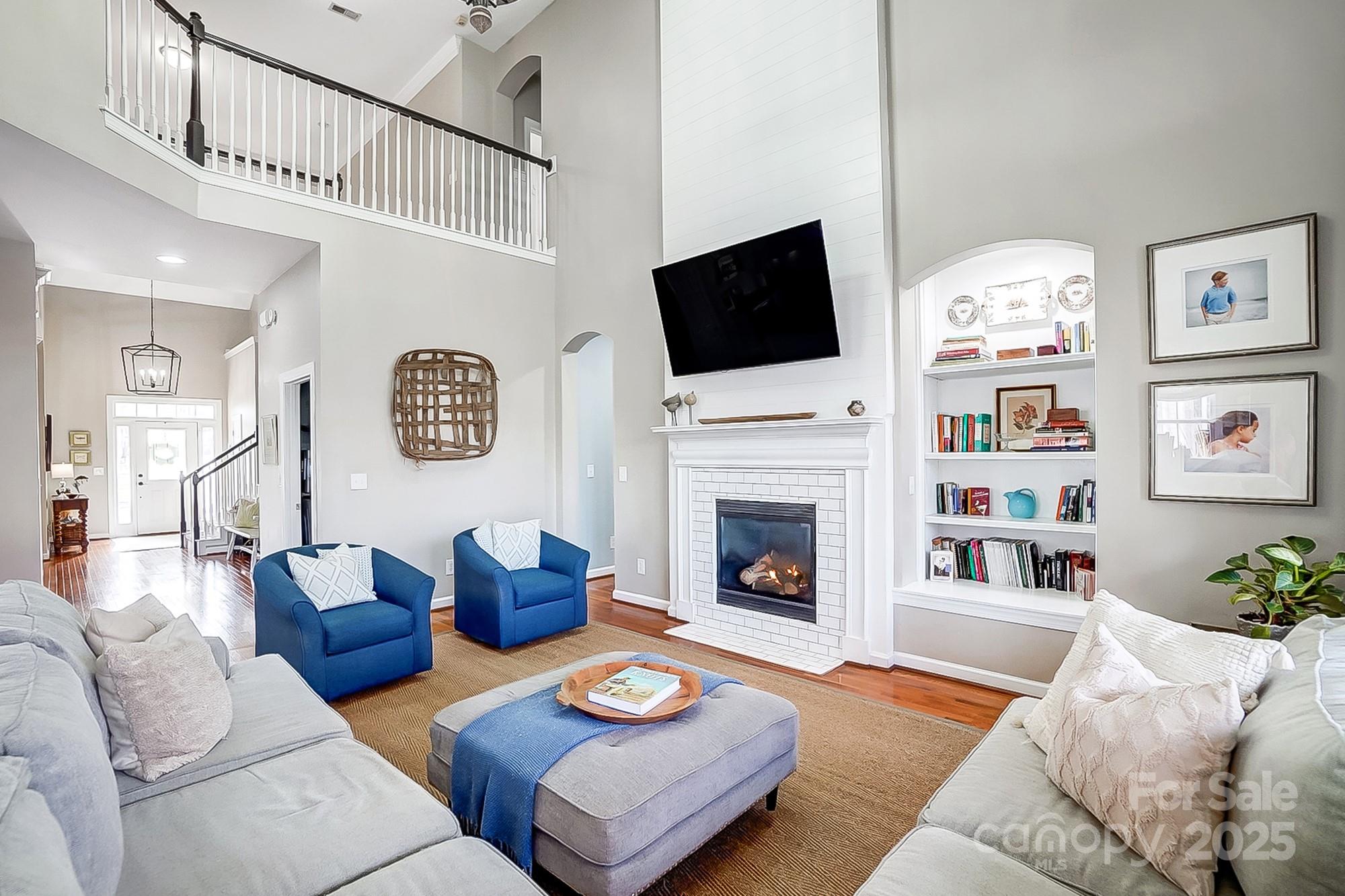 134 Mills Lane Fort Mill, SC 29708 - Photo 4 of 45 a living room with furniture a flat screen tv and a fireplace