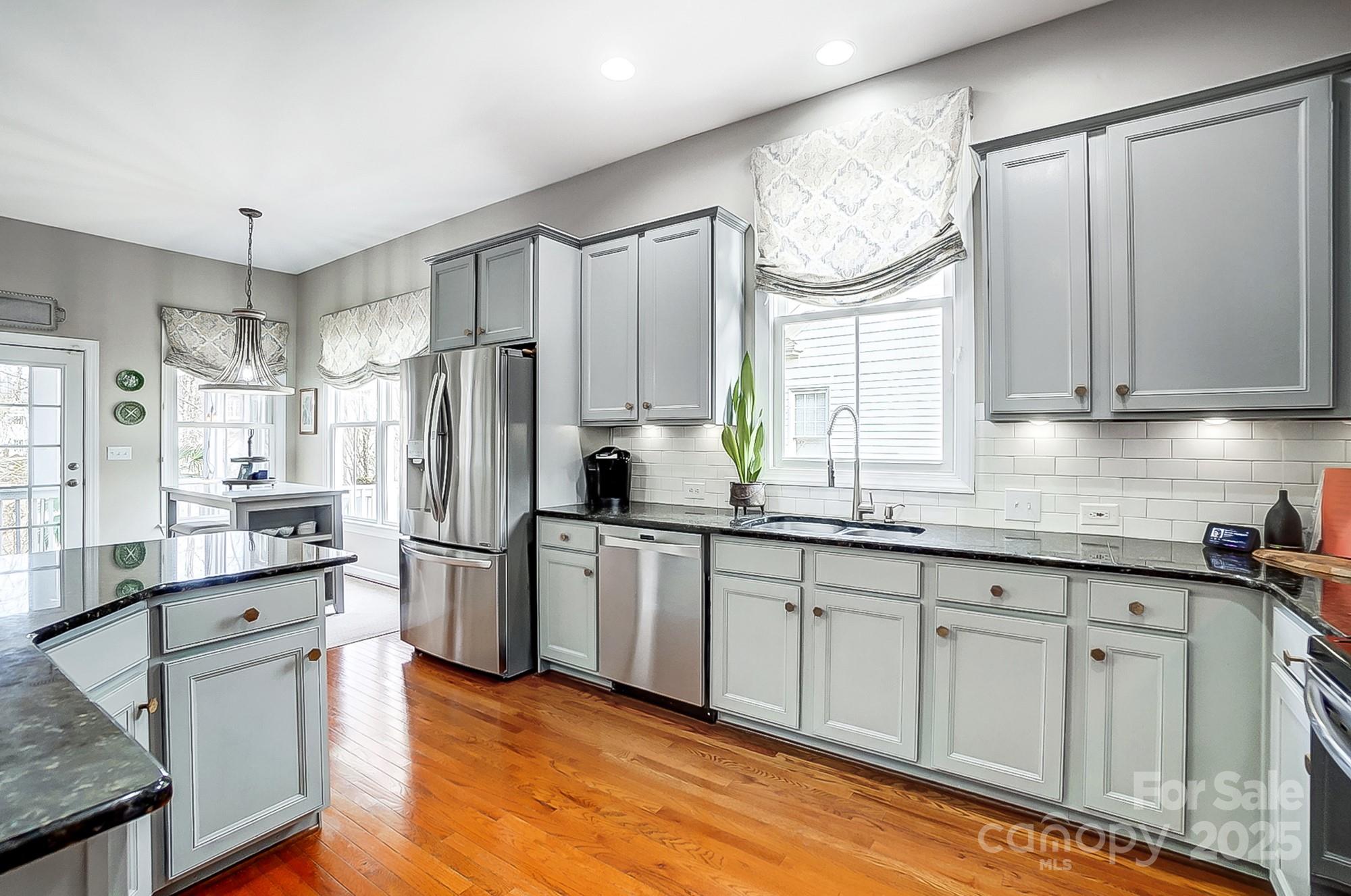 134 Mills Lane Fort Mill, SC 29708 - Photo 10 of 45 a kitchen with white cabinets and stainless steel appliances