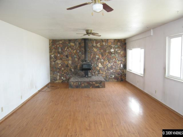 6555 Curry Road Fallon, NV 89406 - Photo 2 of 9 wooden floor in an empty room with a window