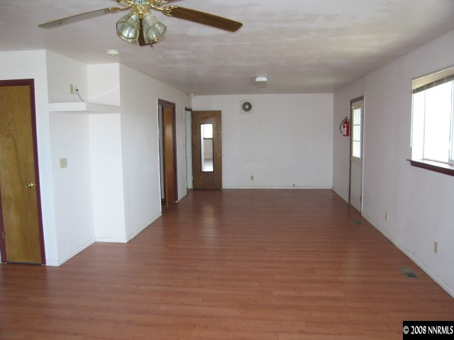 6555 Curry Road Fallon, NV 89406 - Photo 7 of 9 wooden floor in an empty room with a window