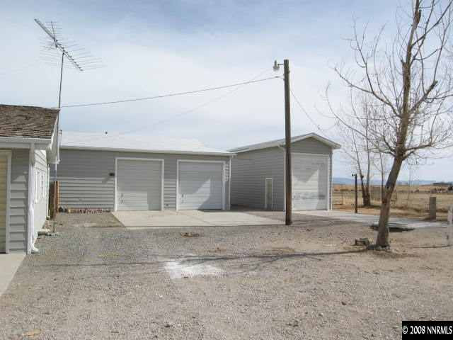 6555 Curry Road Fallon, NV 89406 - Photo 9 of 9 a front view of a house with a yard and garage