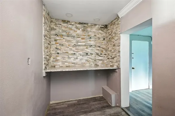 a room with a bench and wooden floor