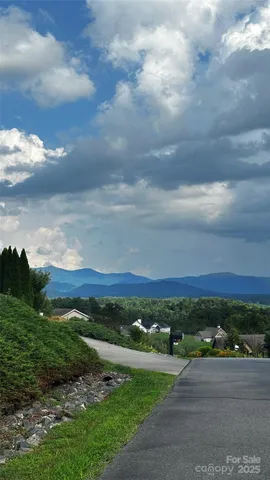 a view of a balcony with wooden floor and fence