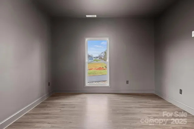 a bathroom with a granite countertop bathtub shower sink vanity mirror and toilet