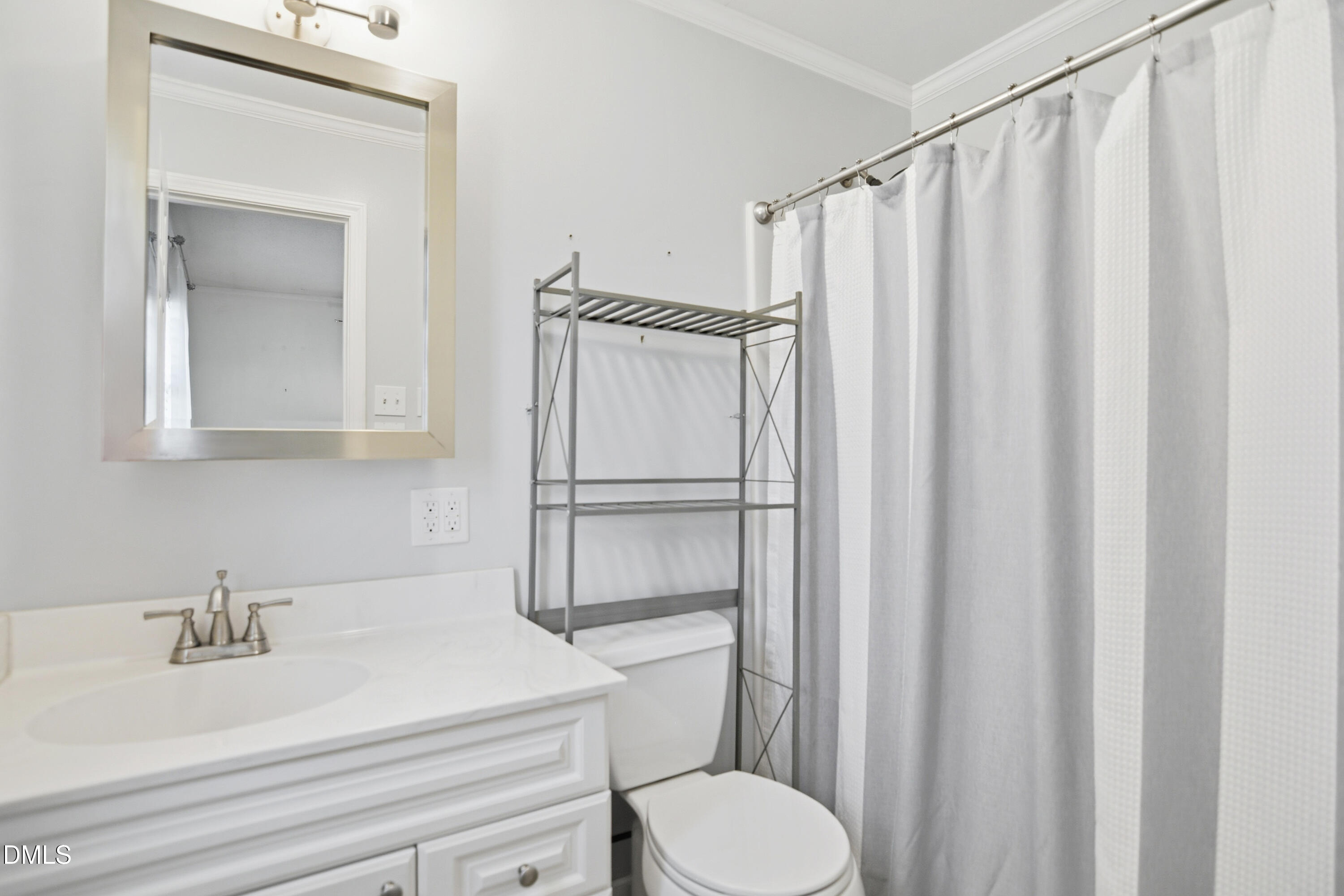 352 Eden Hills Road Siler City, NC 27344 - Photo 12 of 29 a bathroom with a sink a toilet and shower curtain