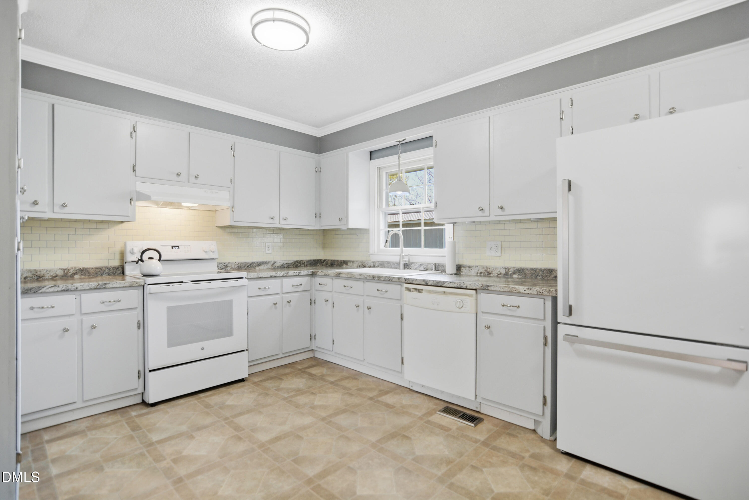 352 Eden Hills Road Siler City, NC 27344 - Photo 6 of 29 a kitchen with granite countertop white cabinets and white appliances