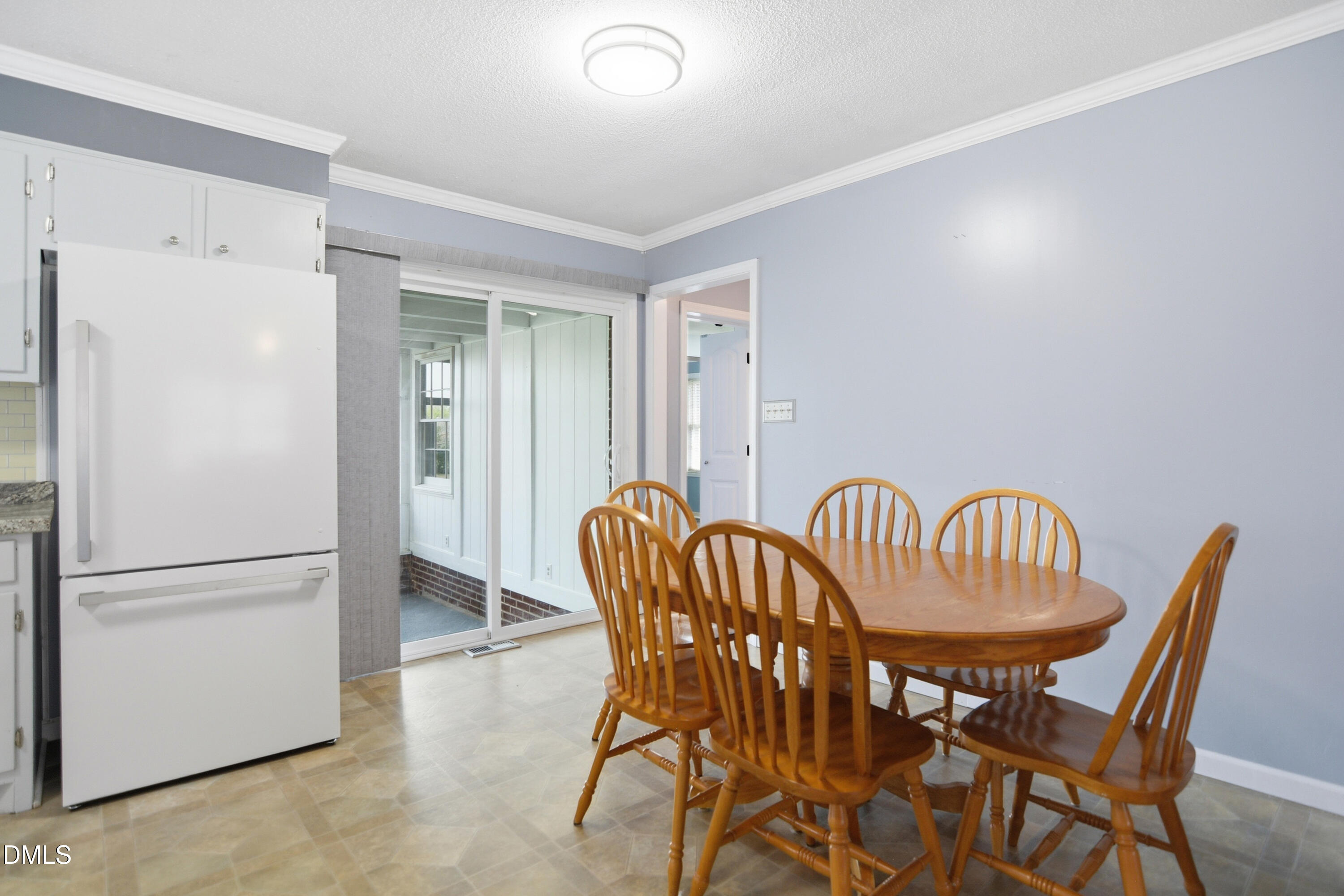 352 Eden Hills Road Siler City, NC 27344 - Photo 9 of 29 a dining room with furniture and a refrigerator