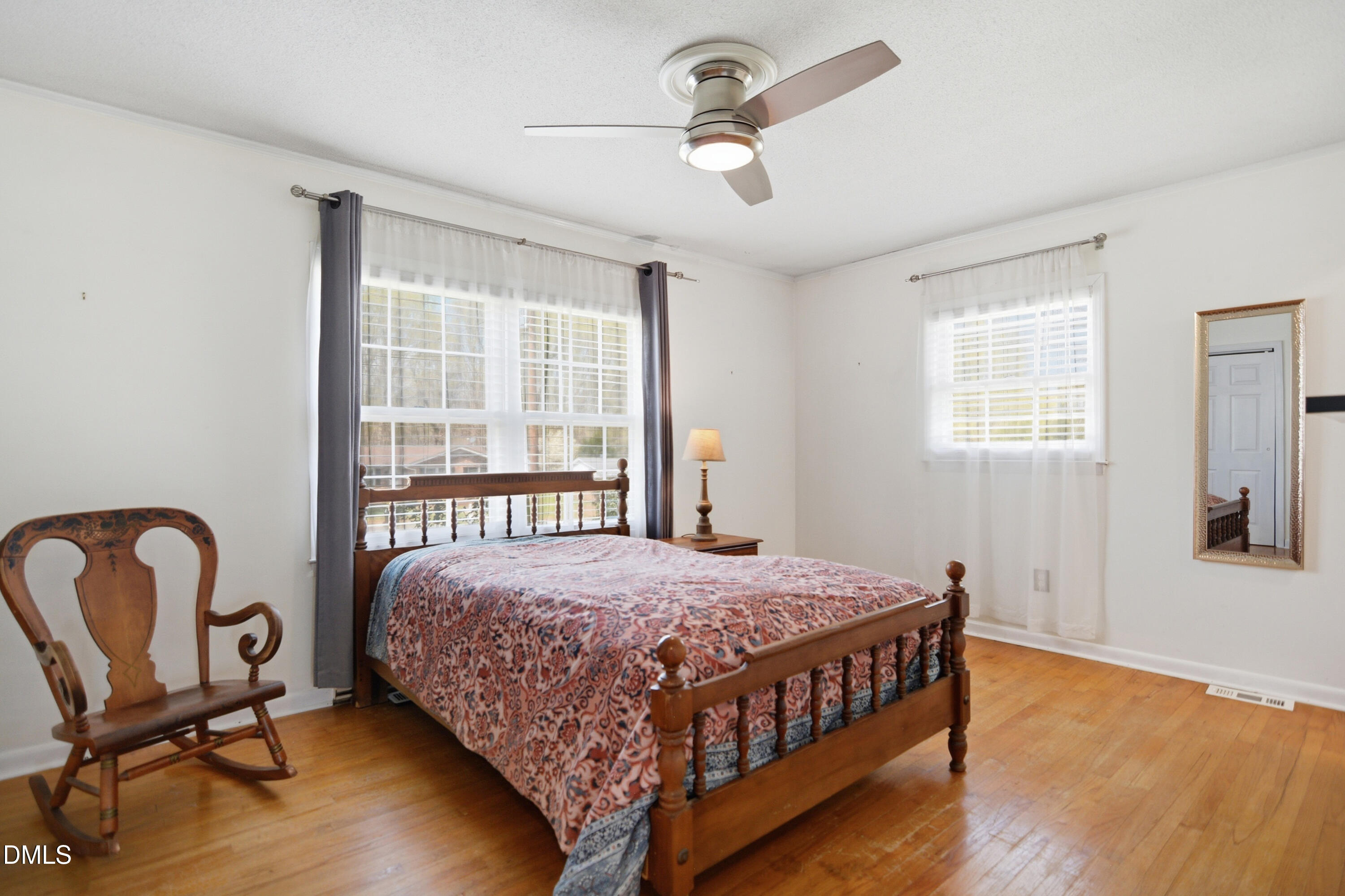 352 Eden Hills Road Siler City, NC 27344 - Photo 10 of 29 a bedroom with a bed windows and wooden floor