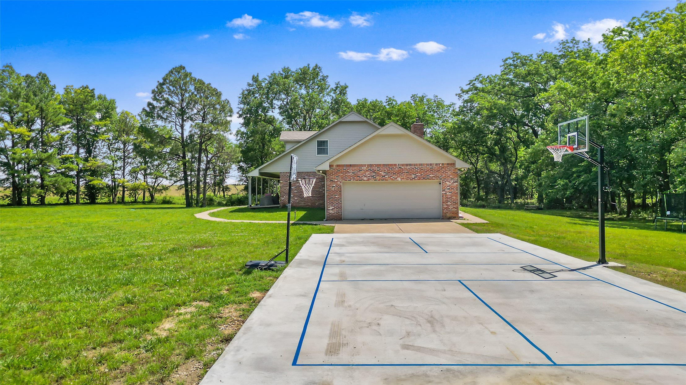 9644 19th Road Nowata, OK 74048 - Photo 7 of 36 Expansive outdoor court with painted lines and a basketball hoop