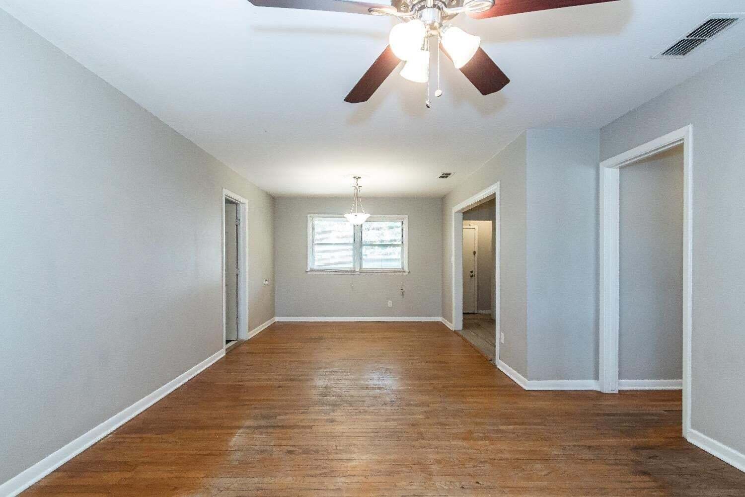 4212 42nd Street Lubbock, TX 79413 - Photo 3 of 18 wooden floor in an empty room with a window