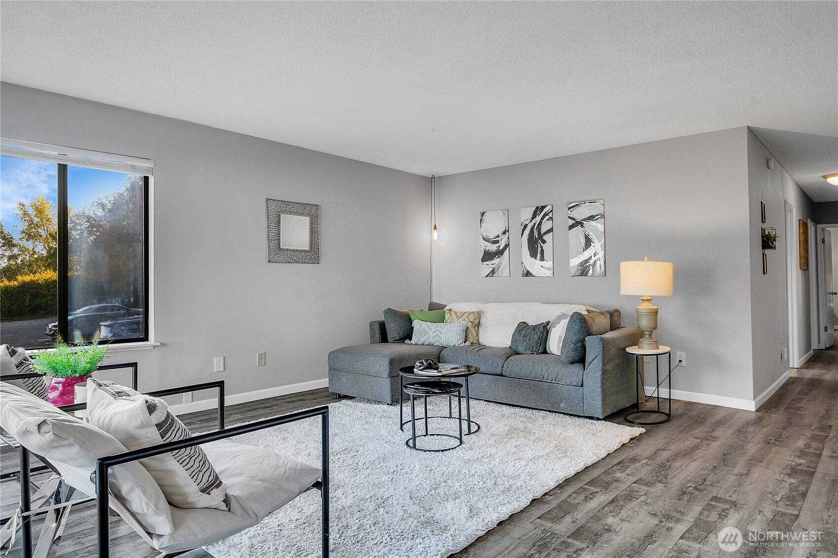 2562 Thorndyke Avenue West, Unit 104 Seattle, WA 98199 - Photo 1 of 18 a living room with furniture and a flat screen tv