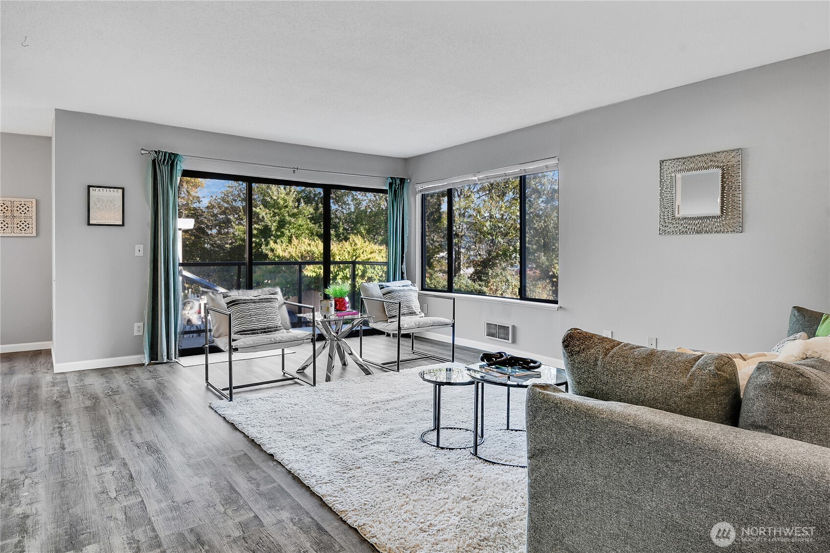 2562 Thorndyke Avenue West, Unit 104 Seattle, WA 98199 - Photo 2 of 18 a living room with furniture and a large window