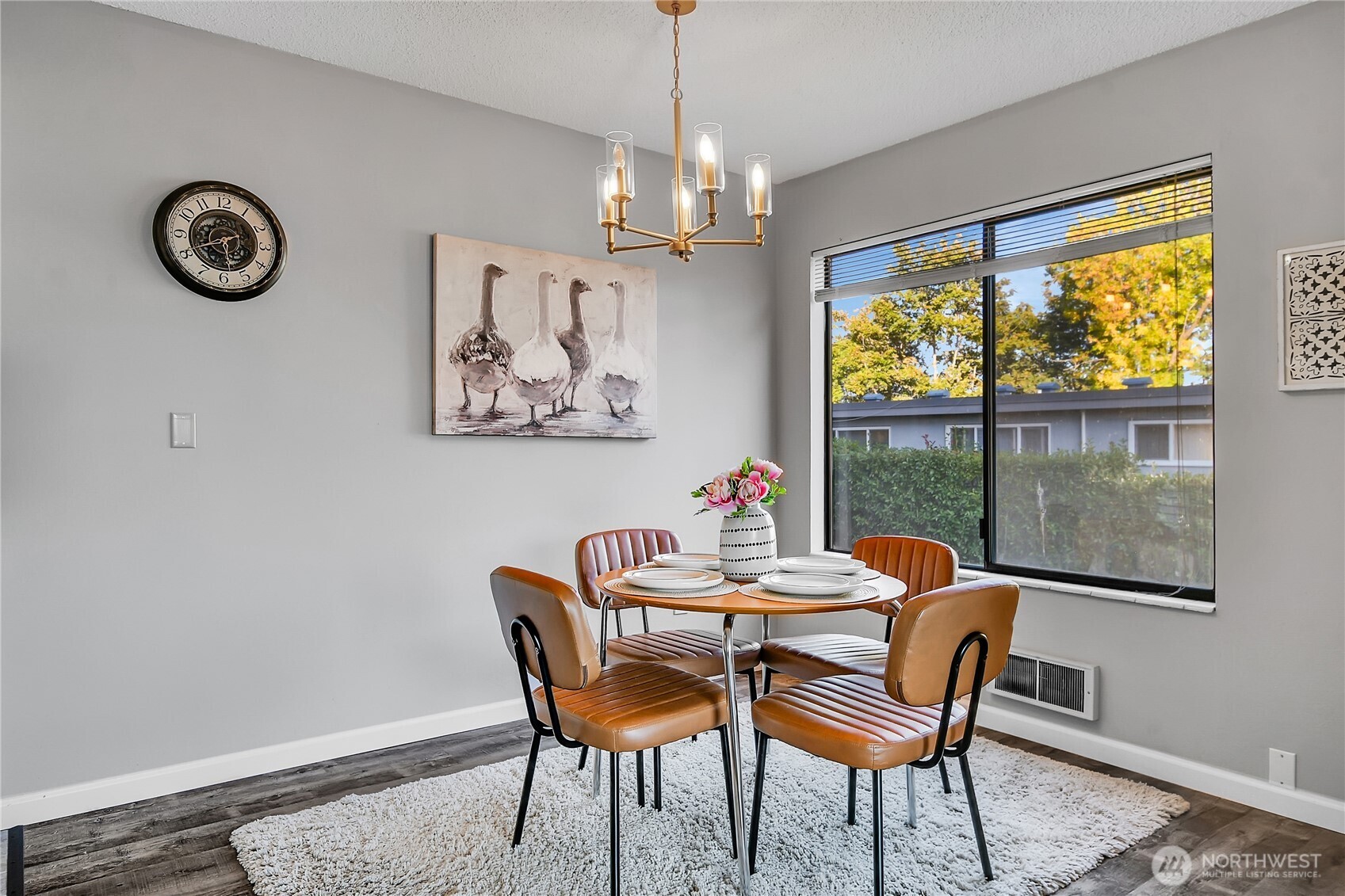 2562 Thorndyke Avenue West, Unit 104 Seattle, WA 98199 - Photo 5 of 18 a dining room with furniture a rug and a large window