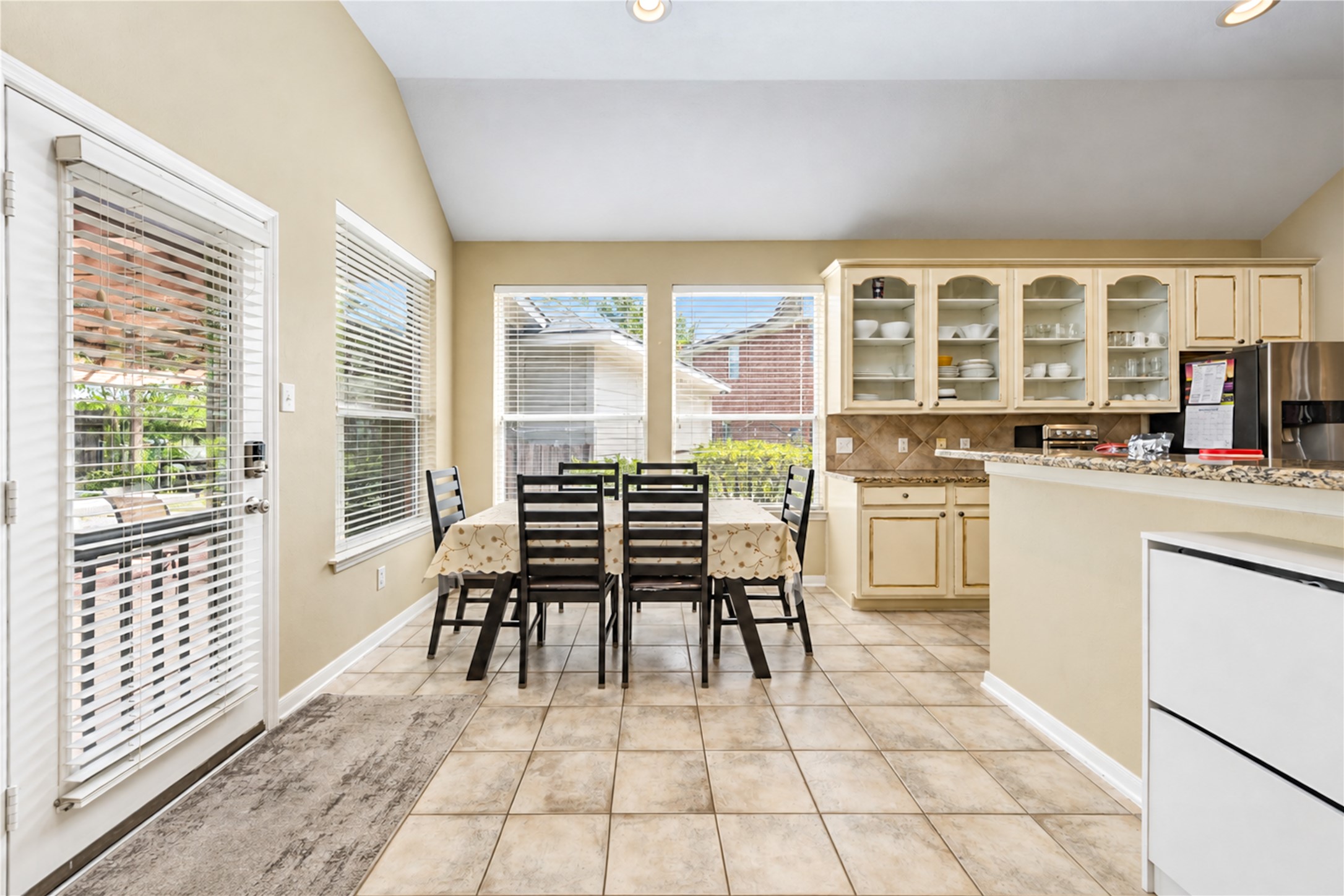 12806 Ridge Bank Lane Houston, TX 77041 - Photo 18 of 44 Bright and inviting kitchen and breakfast area features ample natural light, a spacious layout, and elegant cabinetry, perfect for family gatherings and entertaining.